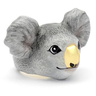 A handmade ring featuring a koala's face, featuring detailed ears and a shiny gold nose, perfect for animal lovers.