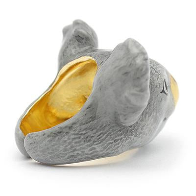 A handmade ring featuring a koala's face, featuring detailed ears and a shiny gold nose, perfect for animal lovers.