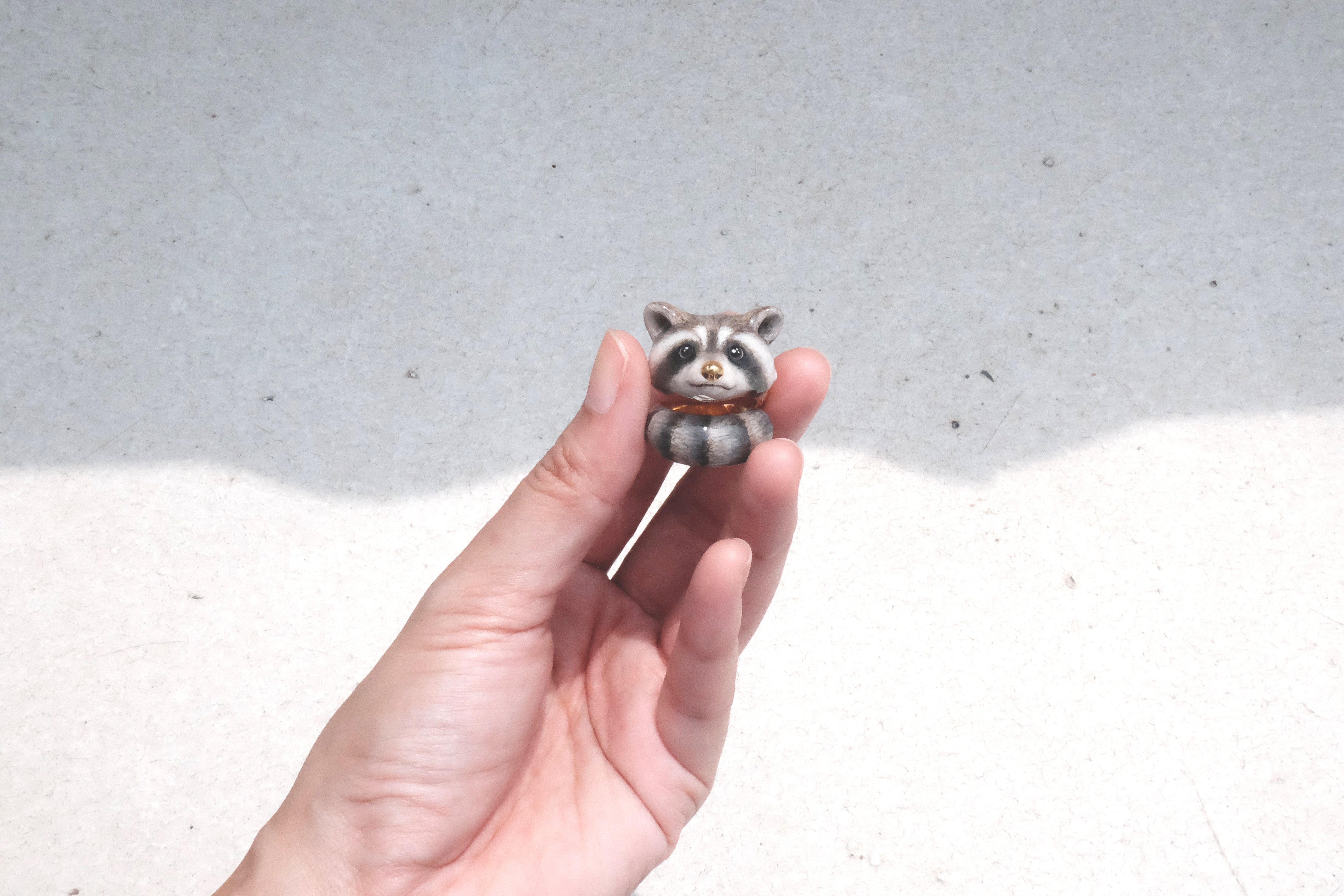 Close-up of a hand showcasing a raccoon ring.