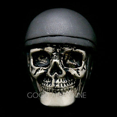 A detailed skull ring featuring a realistic skull design topped with a grey helmet.