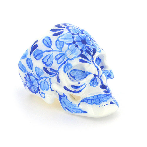 Hand-painted skull ring with artistic blue floral artwork.