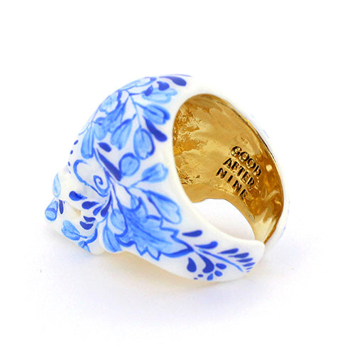 Hand-painted skull ring with artistic blue floral artwork.