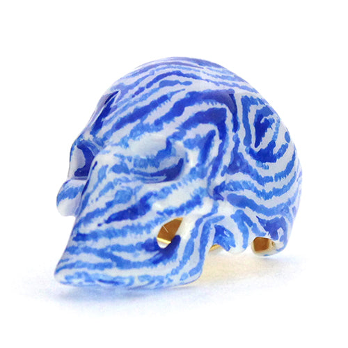 Hand-painted skull ring featuring a unique zebra pattern in blue and white.