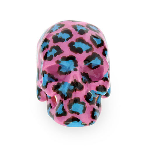 A fashionable skull ring featuring a pink base with a leopard pattern in black and blue
