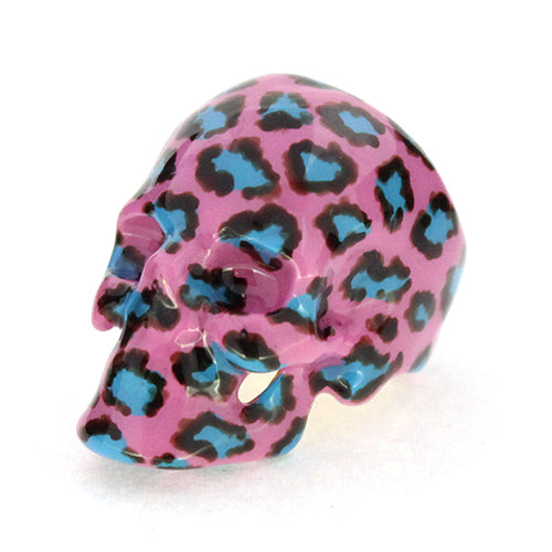 A vibrant skull ring featuring a pink base with a leopard pattern in black and blue, perfect for fashion lovers.