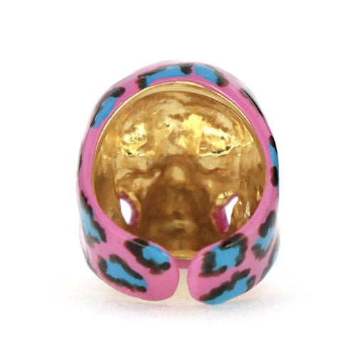 A vibrant skull ring featuring a pink base with a leopard pattern in black and blue