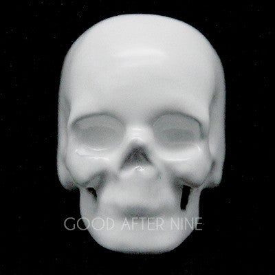 Unique white skull ring featuring a smooth surface and defined facial features