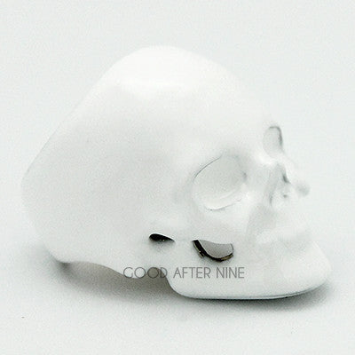 Whimsical white skull ring featuring a smooth surface and defined facial features