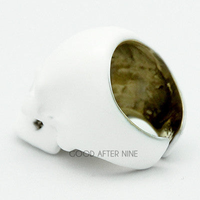 Whimsical white skull ring featuring a smooth surface and defined facial features