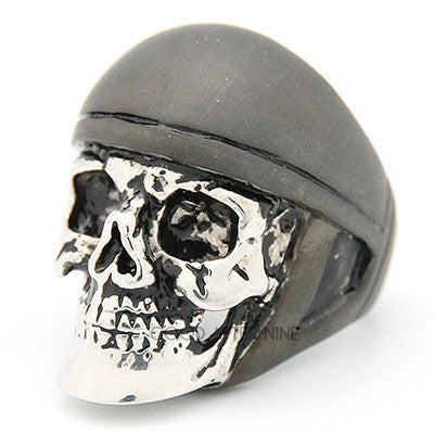 A unique skull ring featuring a realistic skull design topped with a grey helmet.