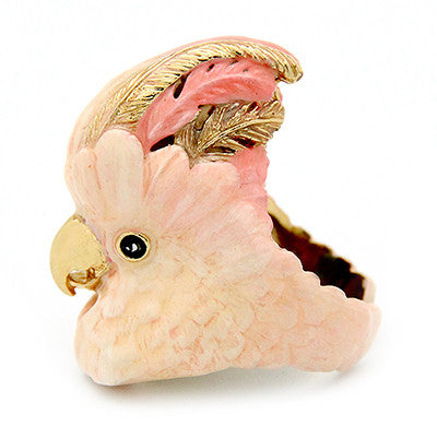 Handcrafted cockatoo-shaped ring in soft pink and gold tones.