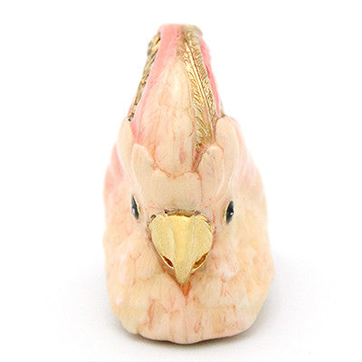 Handcrafted cockatoo-shaped ring in soft pink and gold tones.