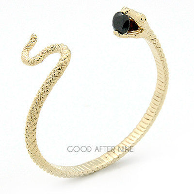 Elegant gold snake bangle with a blue gemstone at its mouth