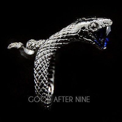 Stylish snake ring with a blue gemstone at its mouth.