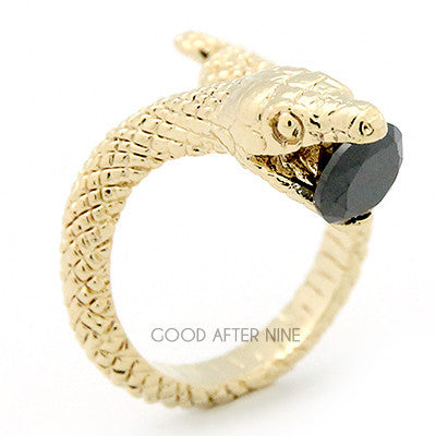 Stylish gold ring featuring snake design with a blue gemstone in its mouth