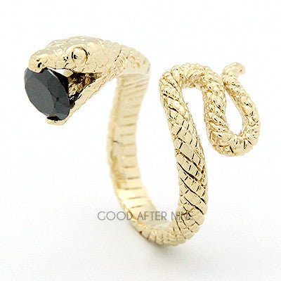 A gold ring featuring snake design, showcasing intricate scales winding around the band, with a blue gemstone in its mouth.