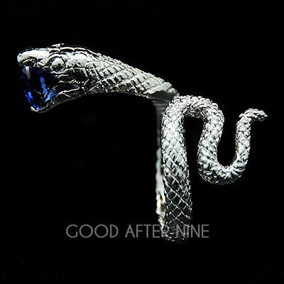 Unique silver snake ring with a blue gemstone in its mouth, perfect for unique jewelry lovers.