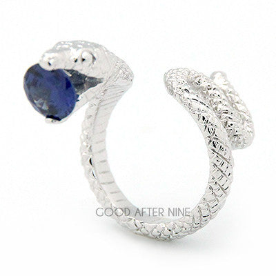 Handcrafted silver ring featuring snake design with a blue gemstone in its mouth, perfect for snake lovers.