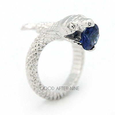 Beautiful silver ring featuring snake design with a blue gemstone in its mouth, perfect for unique jewelry lovers.