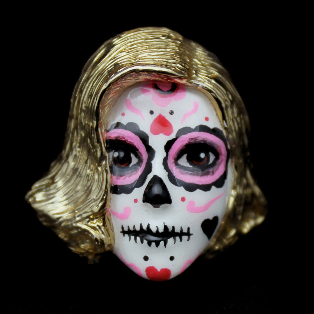 Handmade ring featuring a mask with a skull motif, a blonde wig, vibrant pink and black face paint, and heart-shaped patterns.