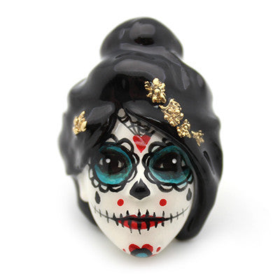 Hand-painted ring featuring a sugar skull with vibrant colors and floral accents.