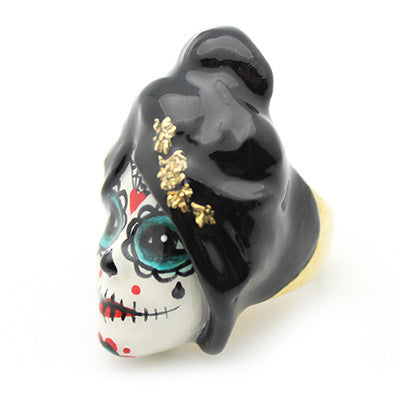 Unique ring featuring a sugar skull with vibrant colors and floral accents.