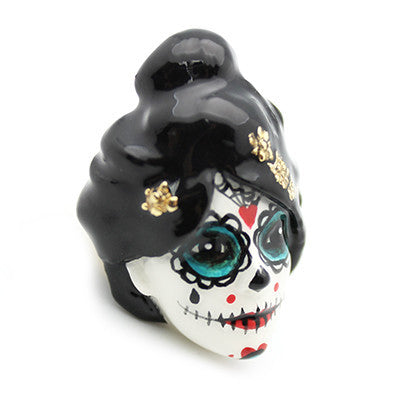 Unique ring featuring a sugar skull with vibrant colors and floral accents.