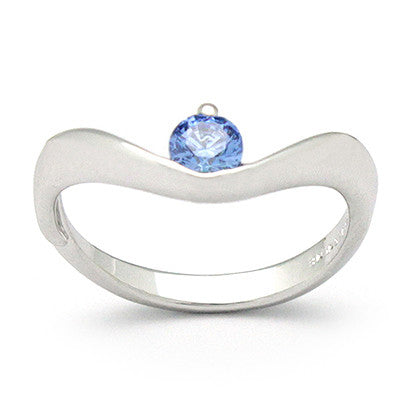 Beautiful silver ring with a blue gemstone set in a wavy band.