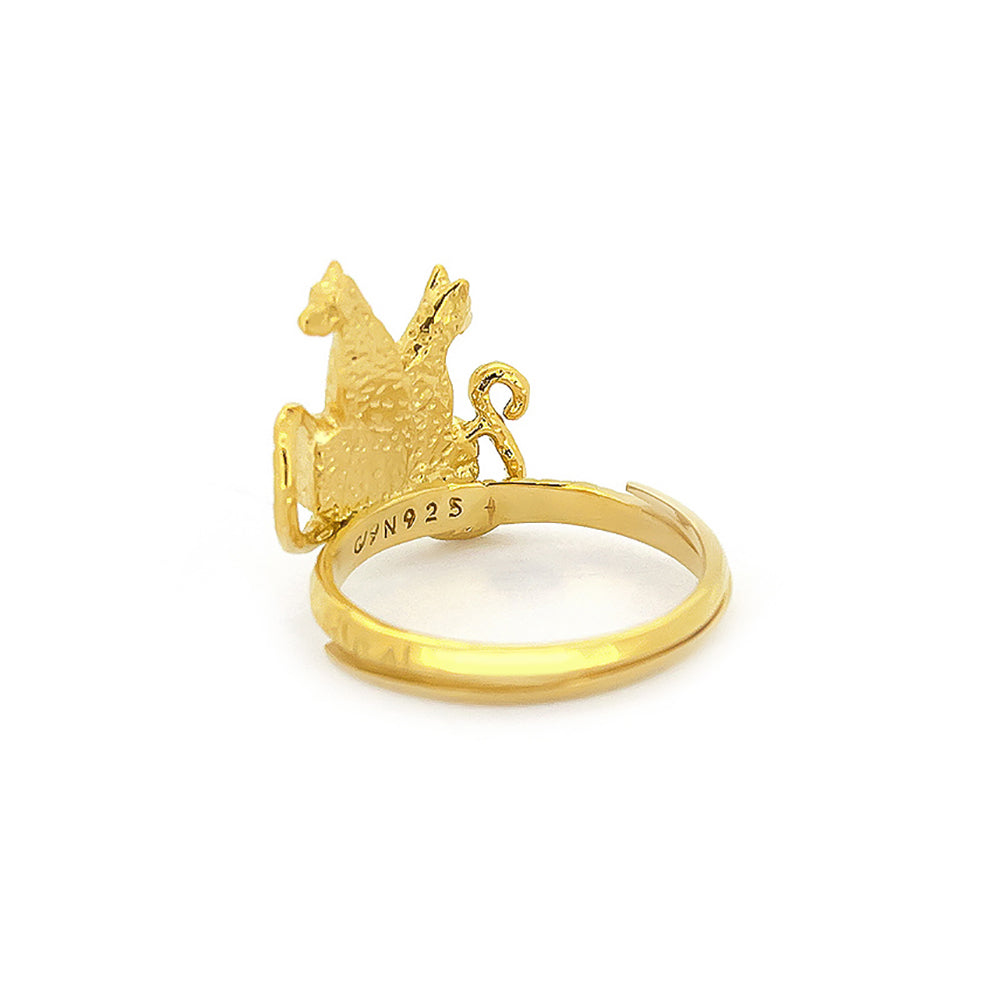 A golden ring featuring two stylized leopards facing each other, adorned with textured detailing and ornate band.