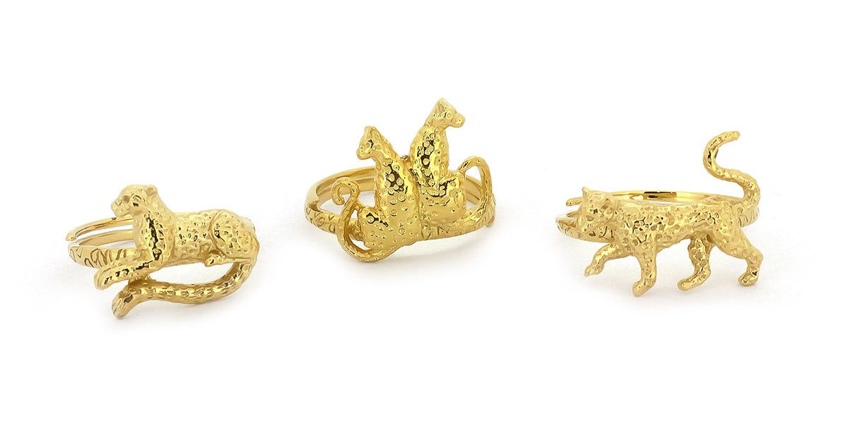 Three ornate gold rings featuring leopard designs.