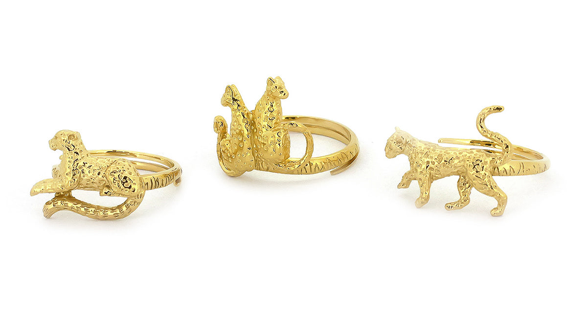 Three ornate gold rings featuring leopard designs.