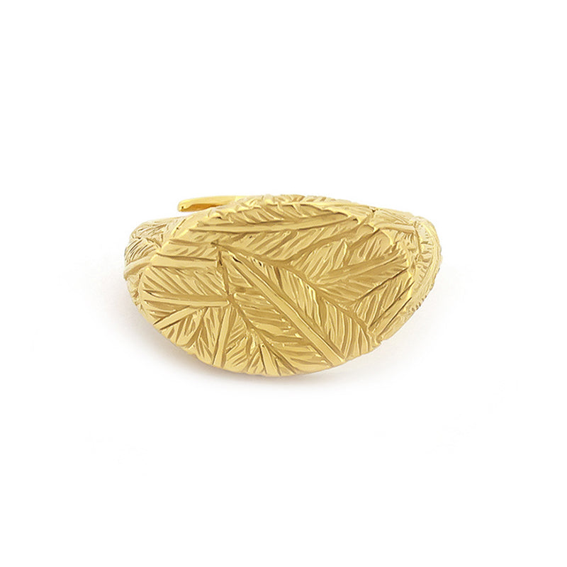 Handcrafted gold ring with distinct textures, featuring a feather pattern.