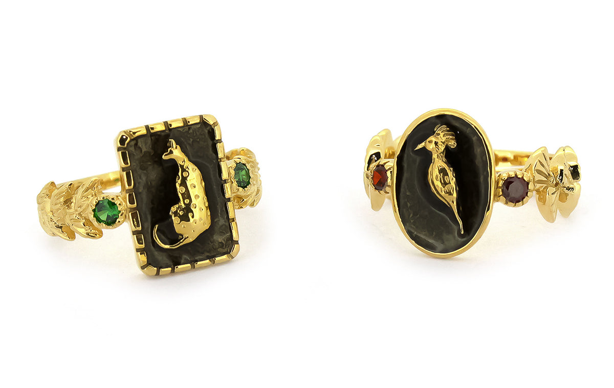 Unique golden rings with animal motifs and vibrant gemstone.