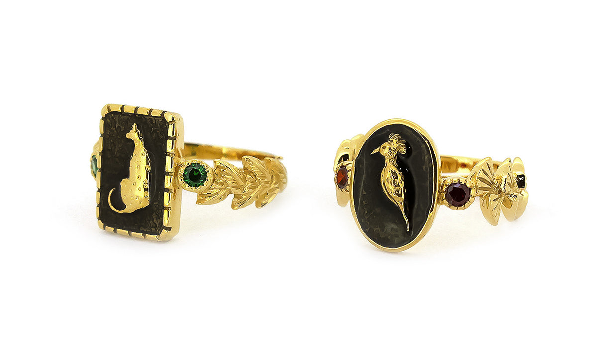 Unique golden rings with animal motifs and vibrant gemstone.