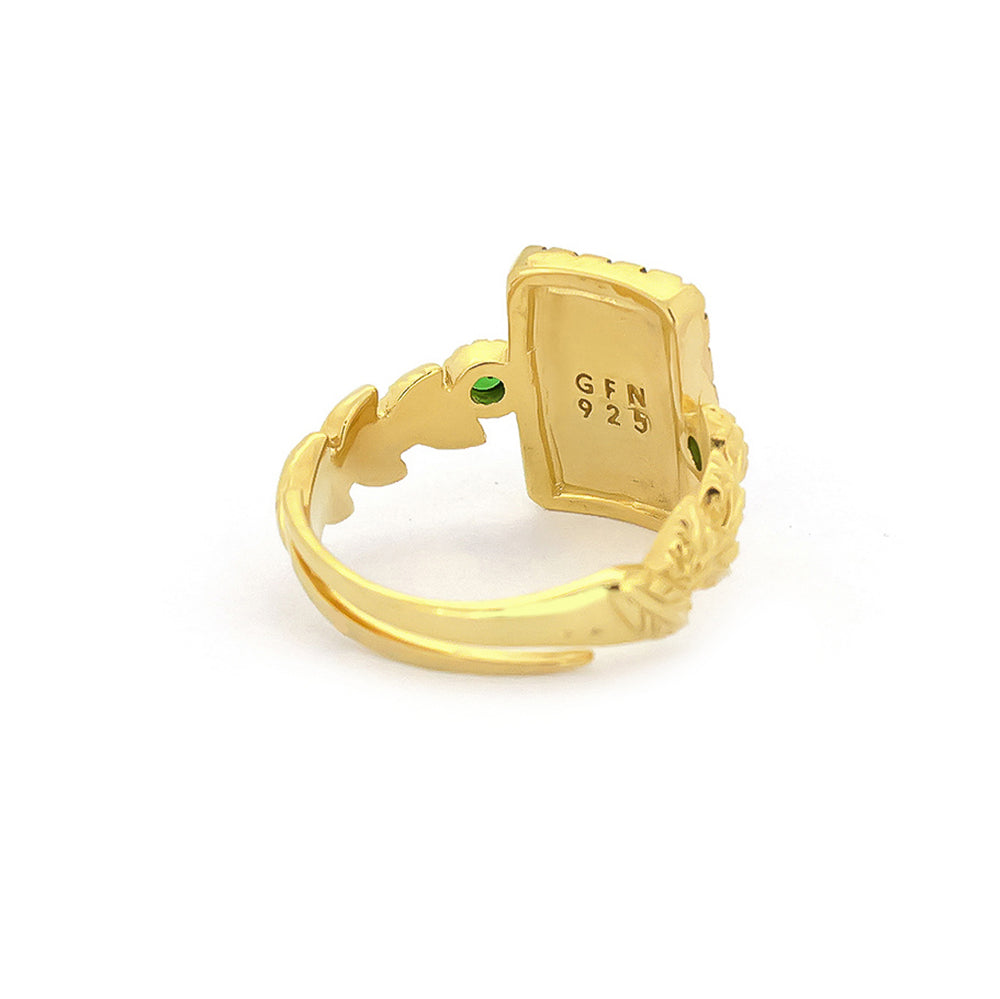 Elegant golden ring featuring a leopard design and green gemstones.