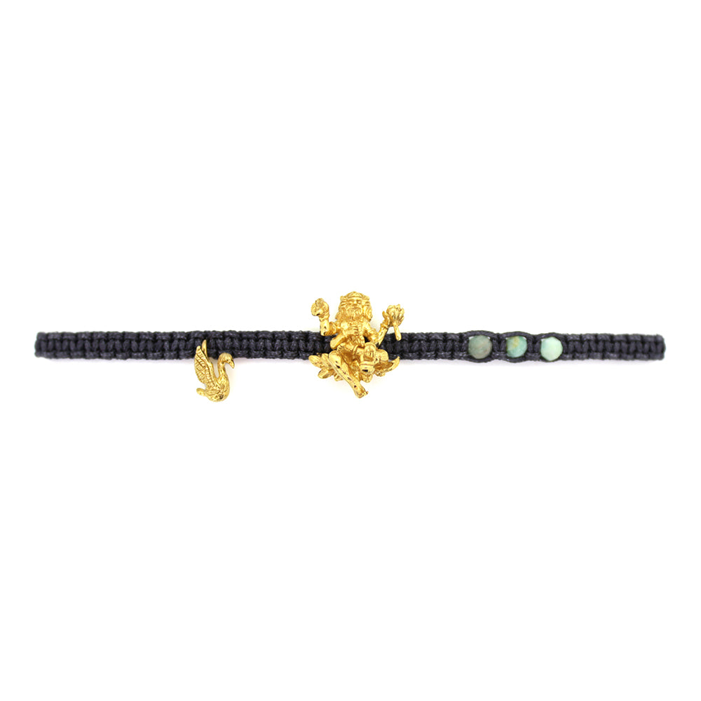 A gold Trimurti Brahma charm and a gold swan charm on a dark grey bracelet with amazonite stone.