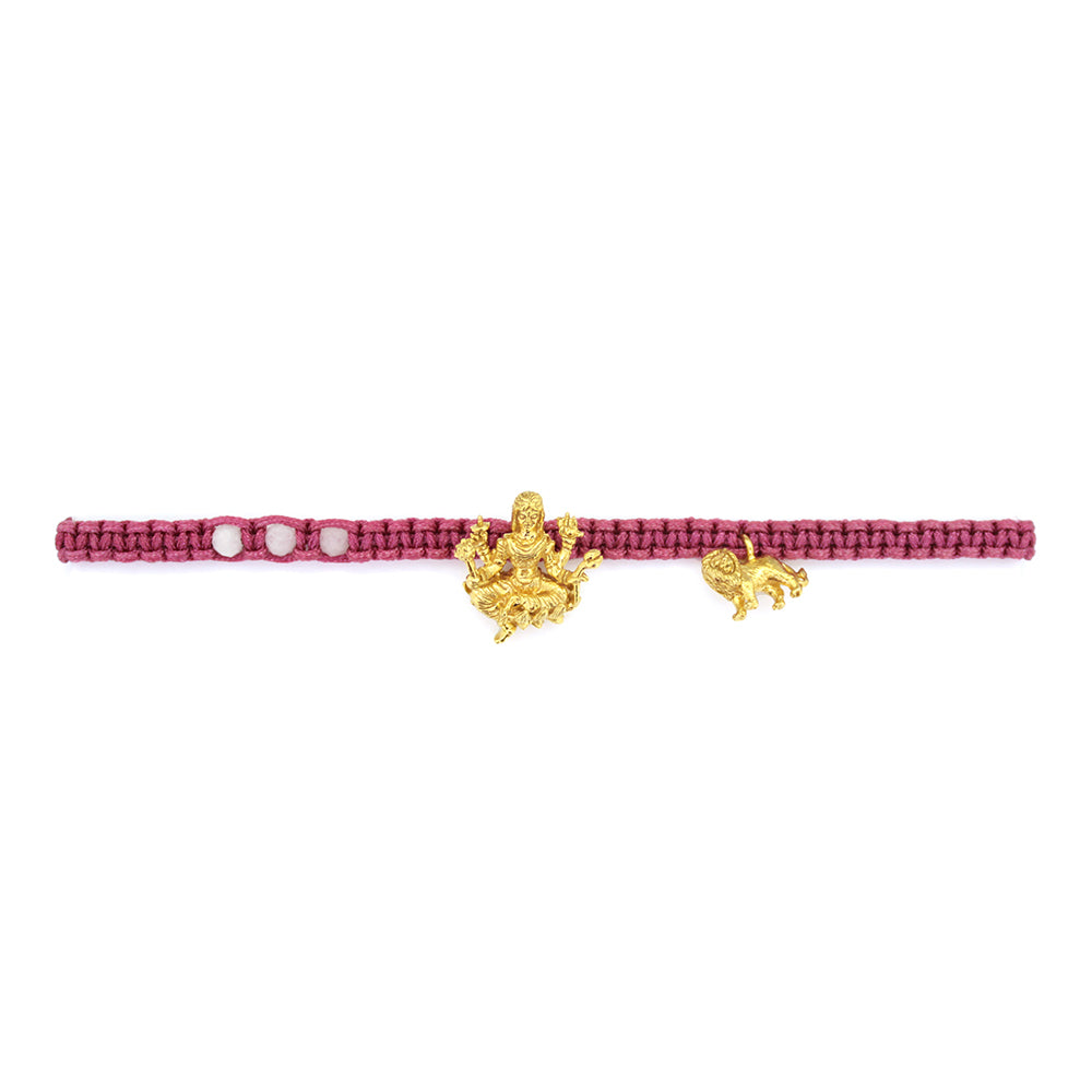 A gold Tridevi Parvati charm and a gold lion charm on a pink bracelet with moonstone stone.