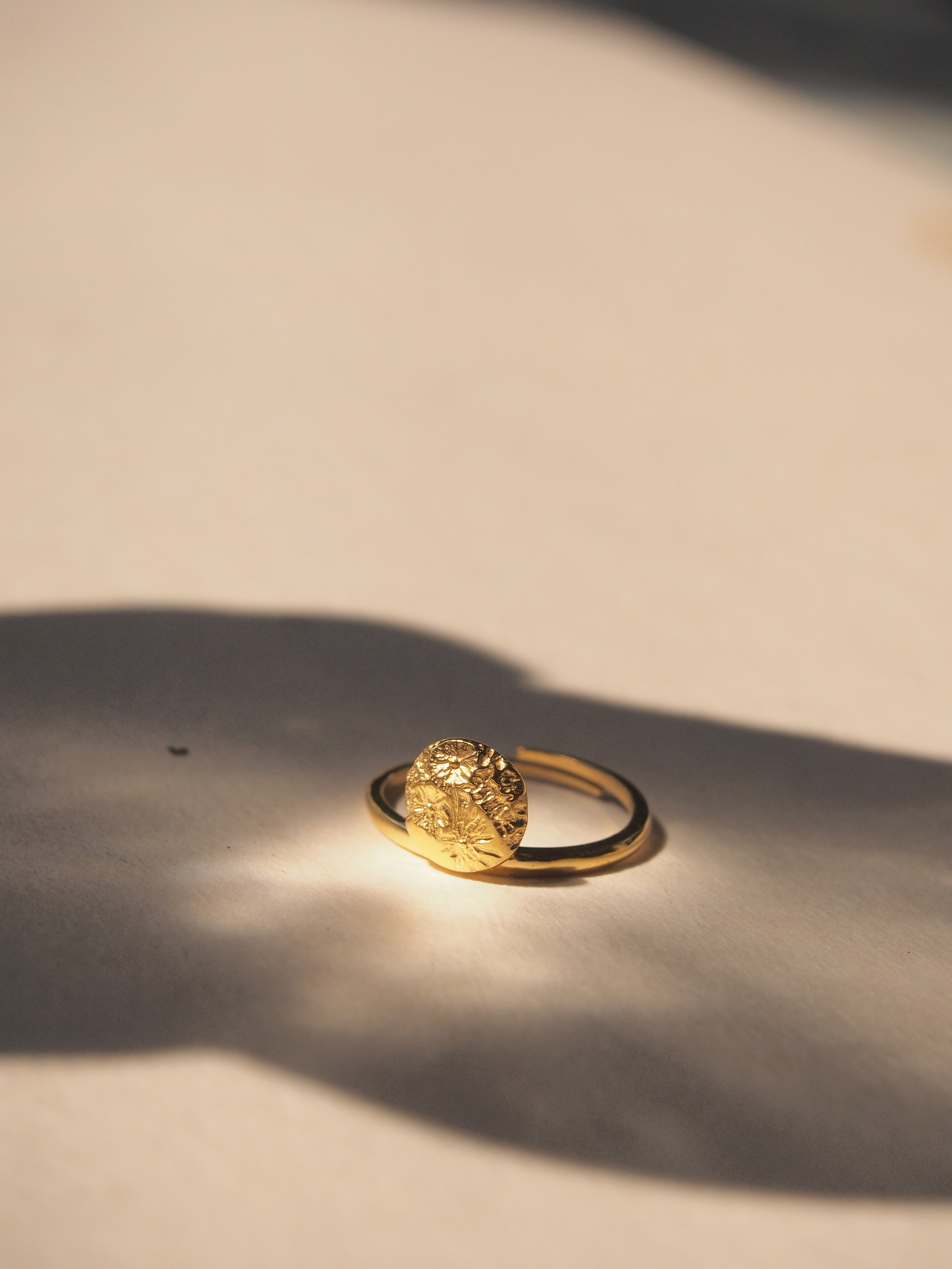 Close-up of a moon-inspired ring with intricate details.