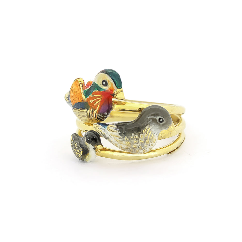 A set of three gold rings featuring colorful, intricately designed mandarin duck motifs in varying sizes.