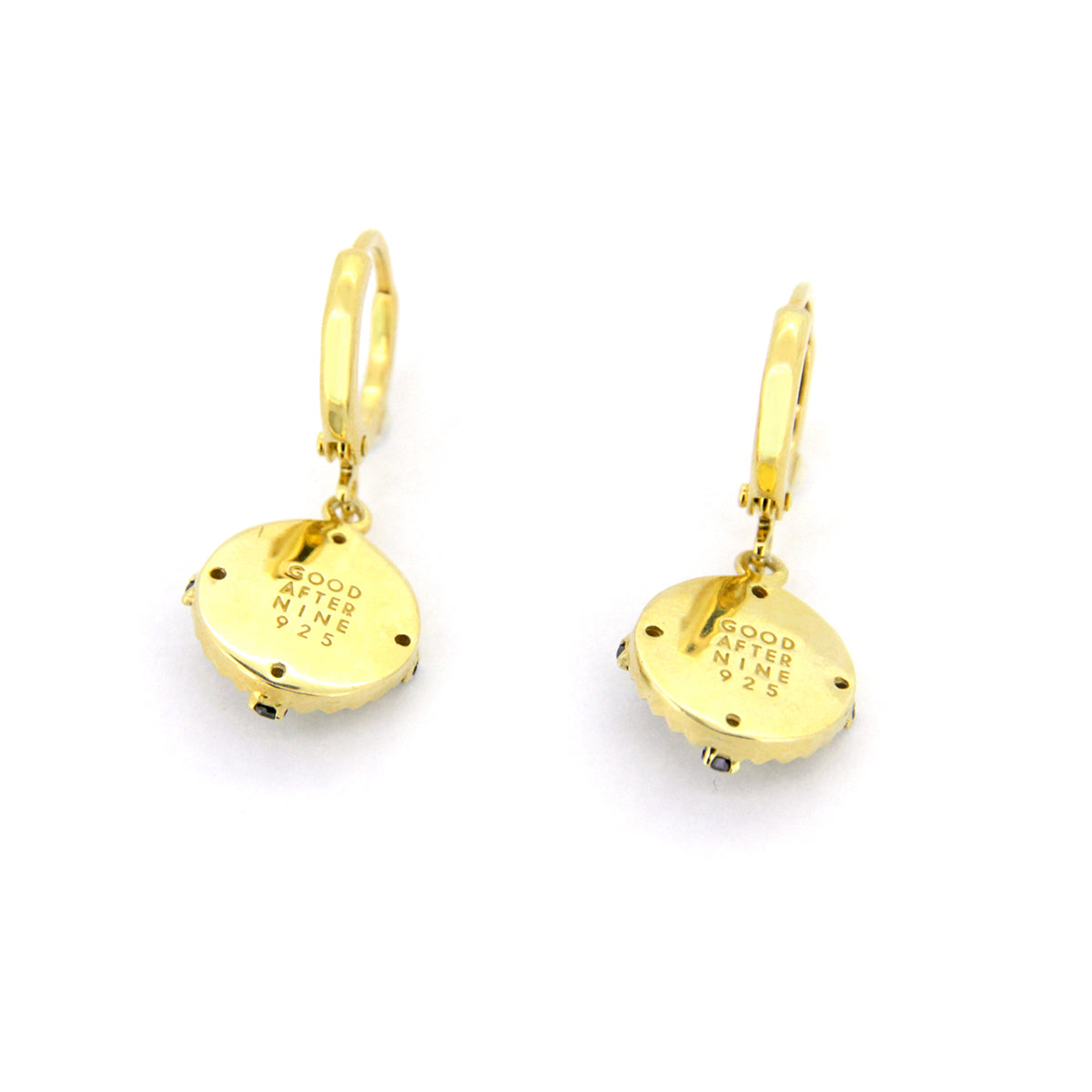 Beautiful gold earrings featuring a cat face motif surrounded by a black circular design.