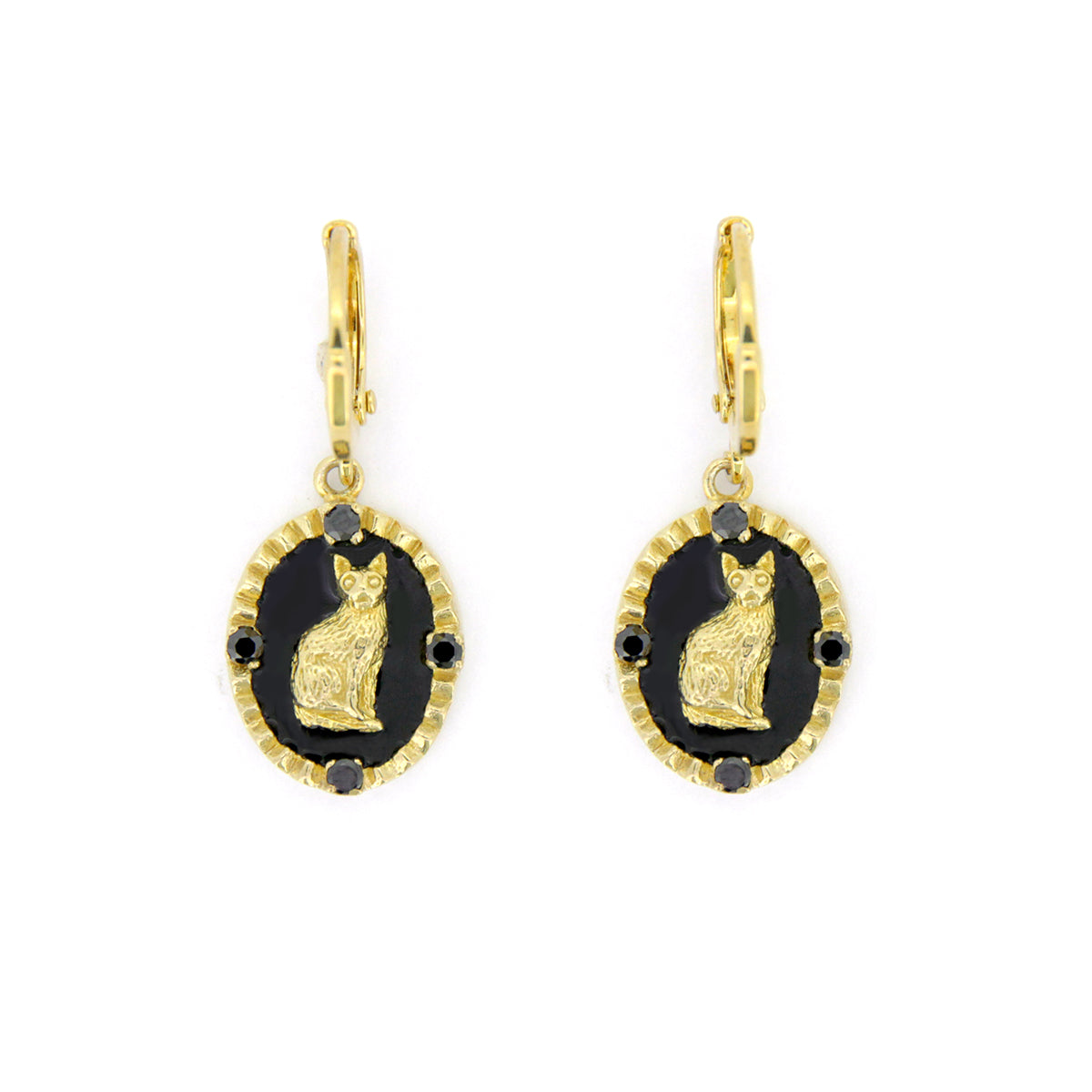 Gold cat earrings on a black oval background with decorative elements.

