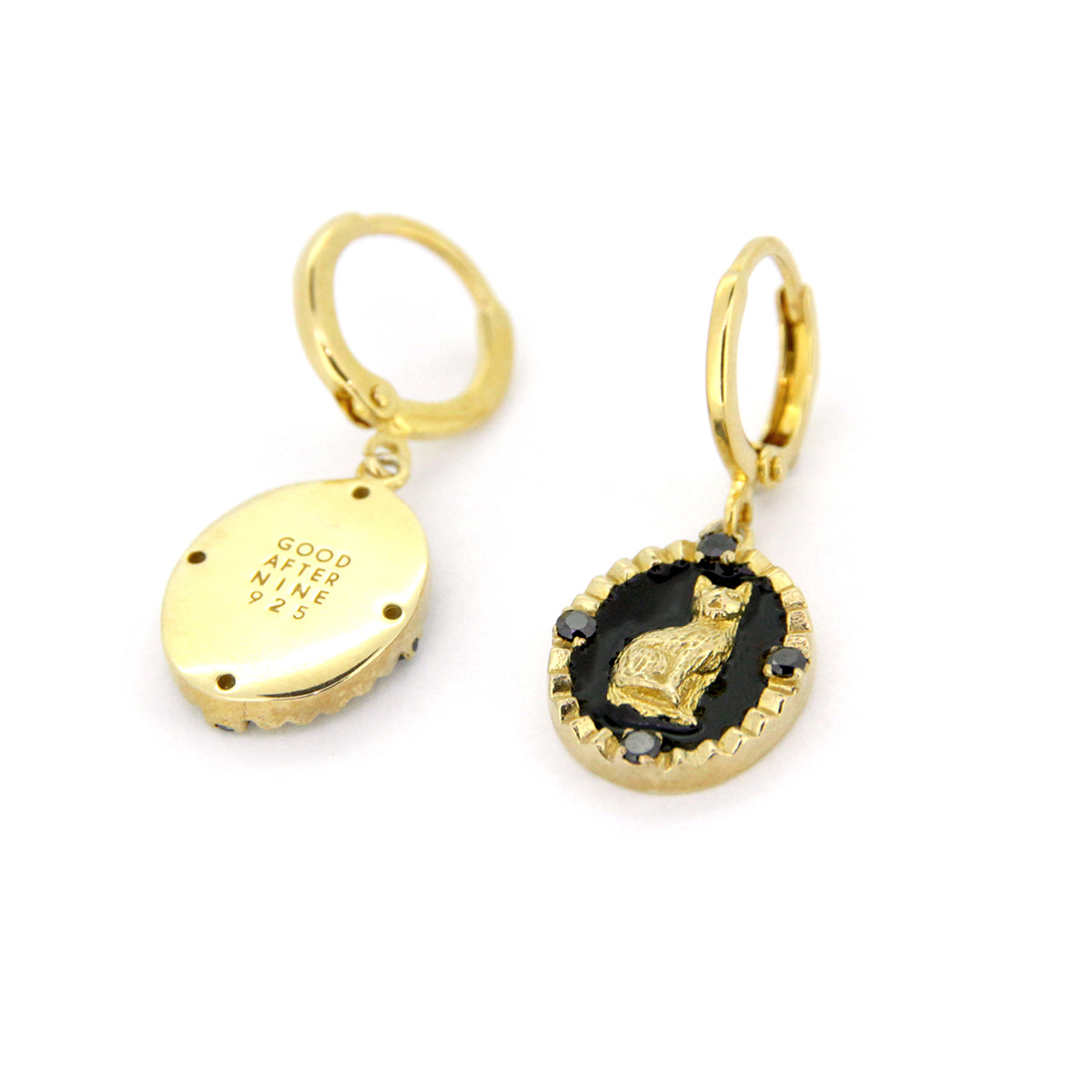 Gold cat earrings on a black oval background with decorative elements, perfect for animal lovers.