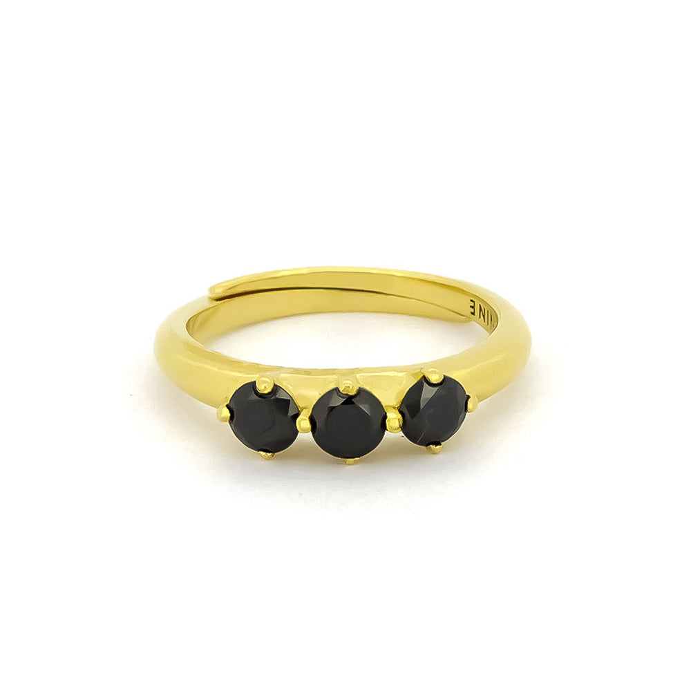 Gold ring with three black synthetic gemstones