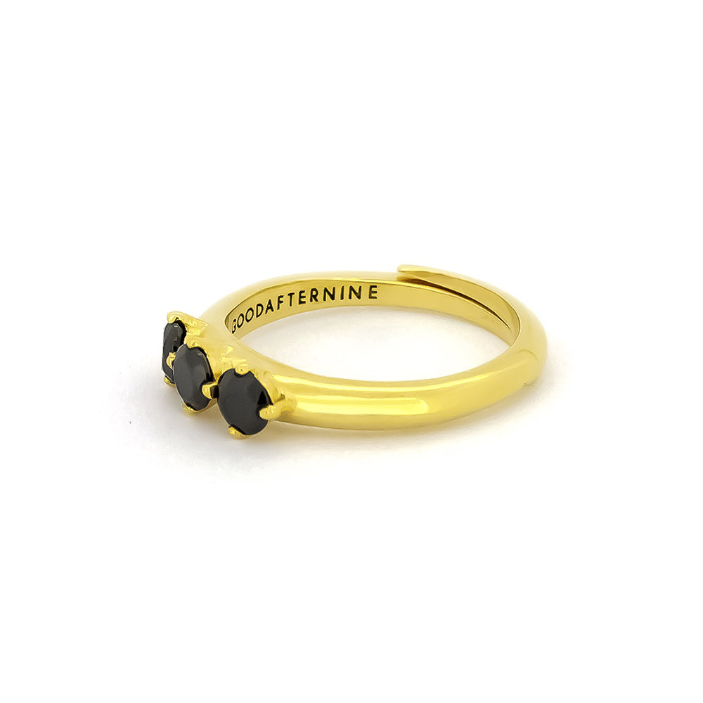 Elegant gold ring with three black synthetic gemstones