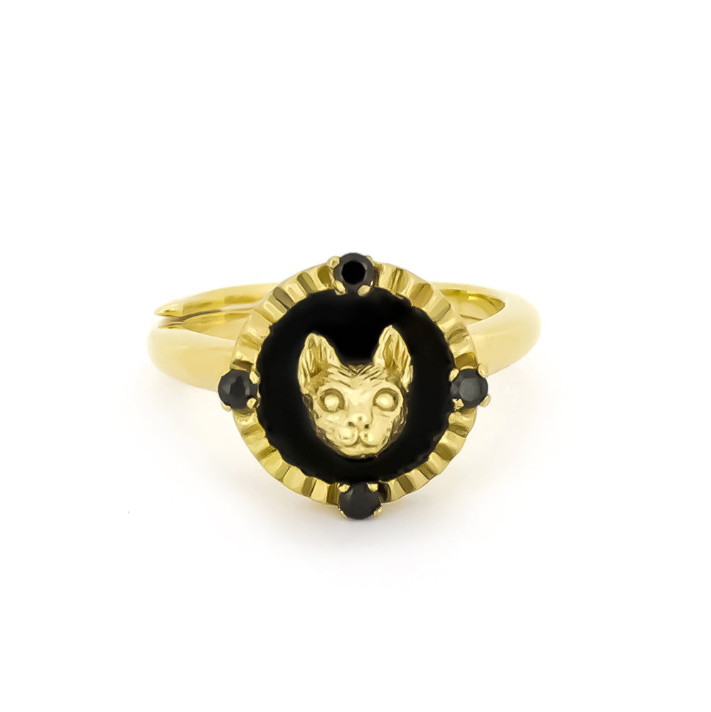 Elegant gold cat ring featuring four small black synthetic gemstones.