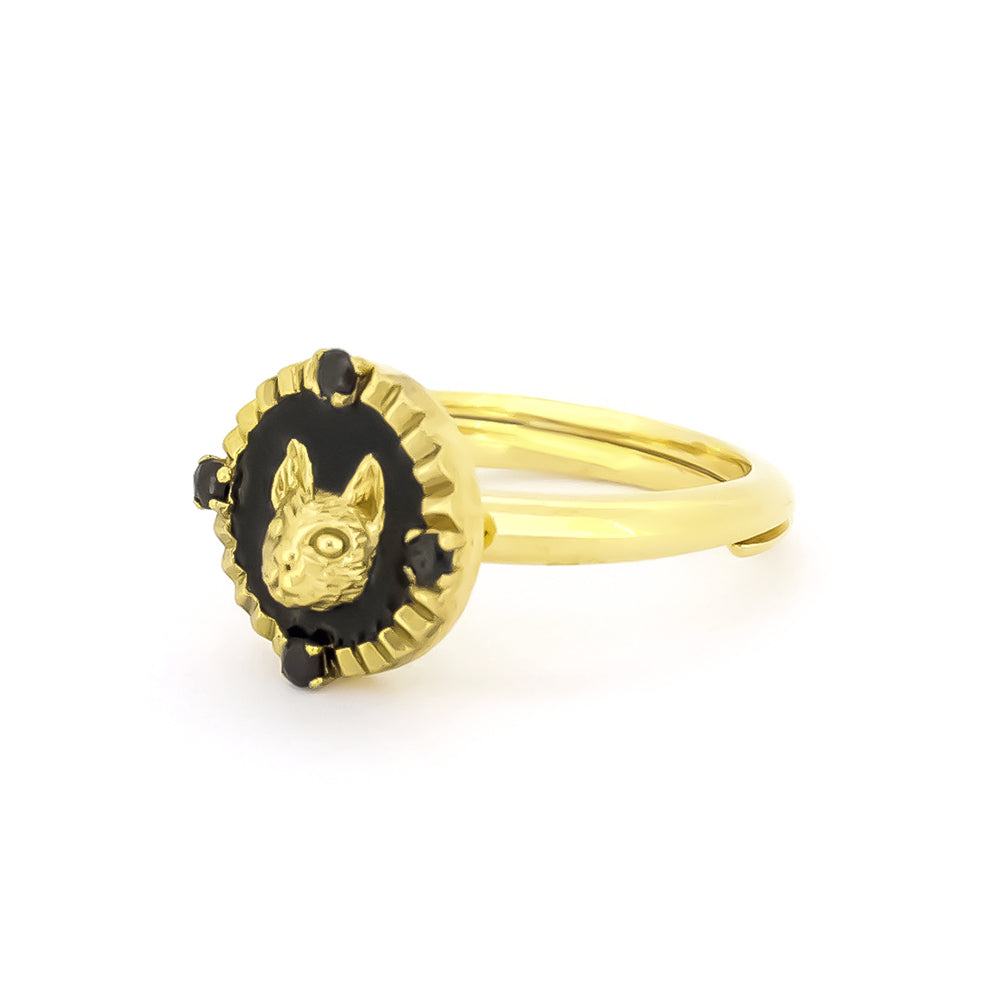 Elegant gold cat ring featuring four small black synthetic gemstones.