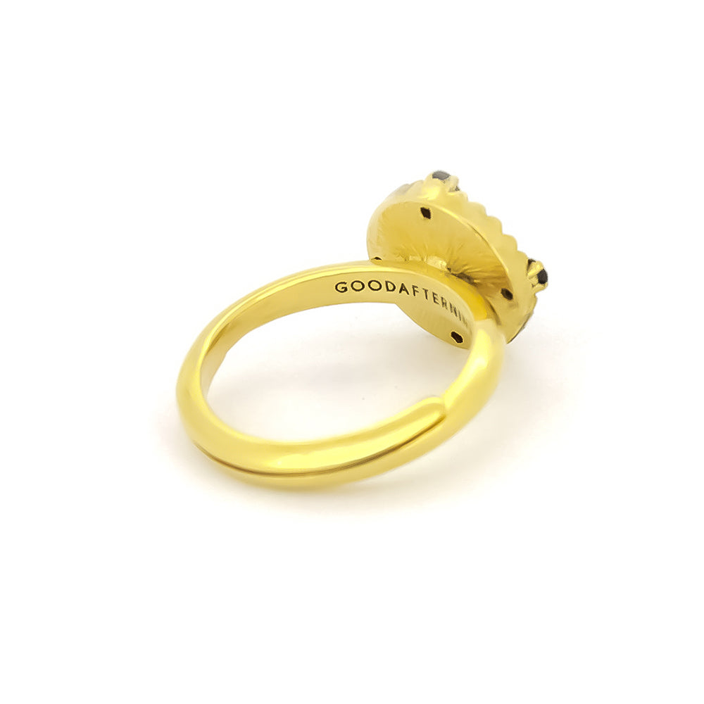 Beautiful gold cat ring featuring four small black synthetic gemstones.