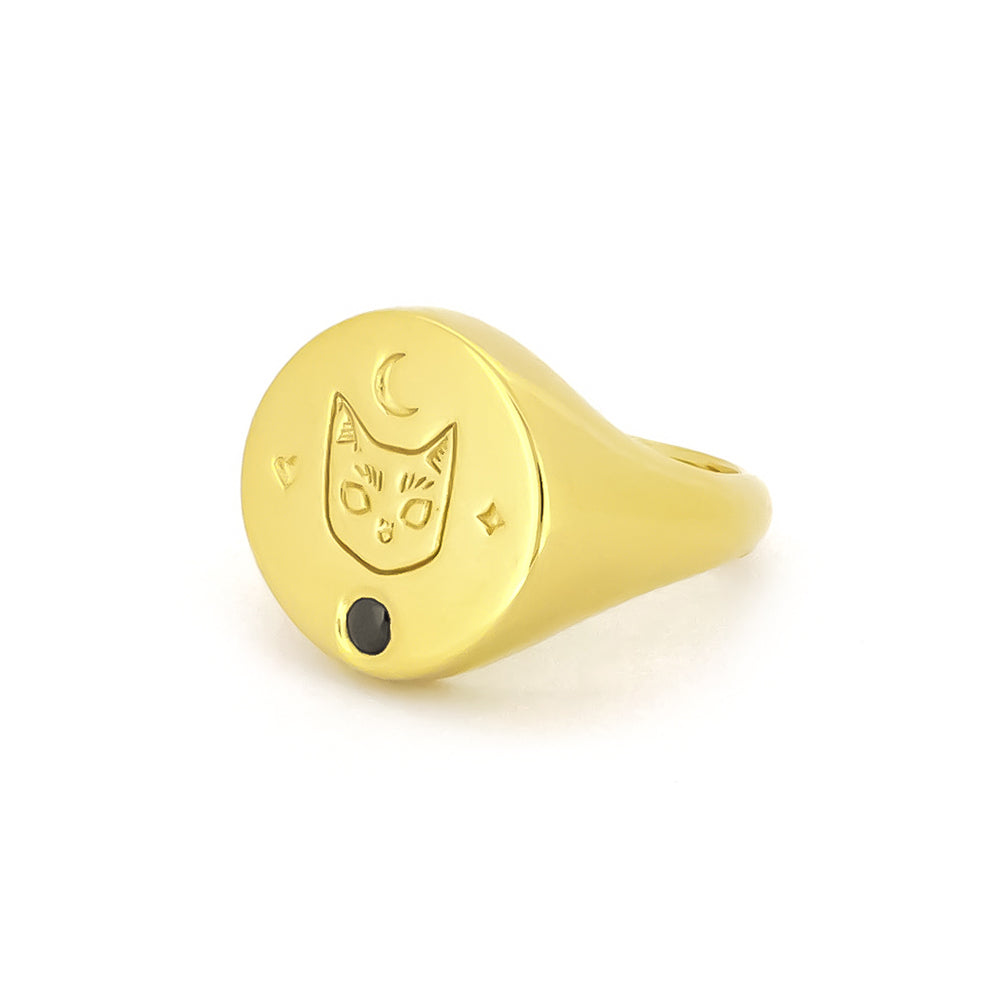 Gold signet ring featuring a cat design with a synthetic black gemstone and moon motifs, perfect for cat lovers.