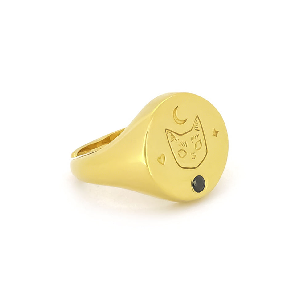 Gold signet ring featuring a cat design with a synthetic black gemstone and moon motifs, perfect for cat lovers.