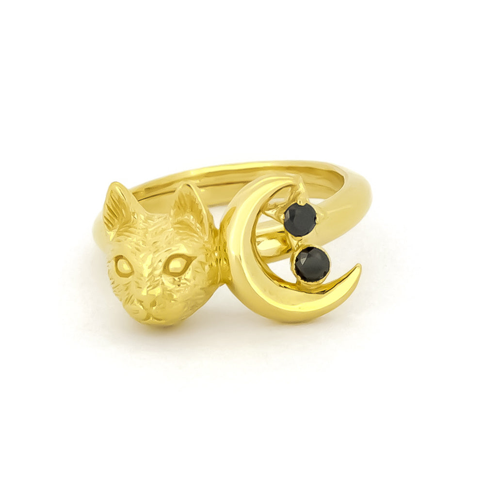 Gold ring featuring a cat head and crescent moon with two black gemstones.